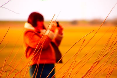 Man playing on field during sunset