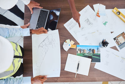 Cropped image of business colleagues working on table