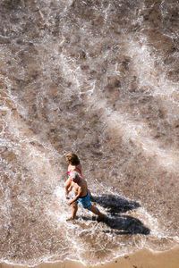 Full length of teenage boy on beach