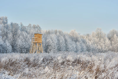 Snow covered landscape against clear sky