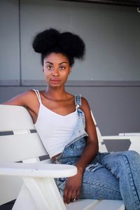 Portrait of young woman sitting on table