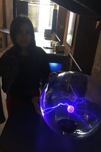 Portrait of woman standing in illuminated room