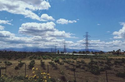 Scenic view of field against cloudy sky