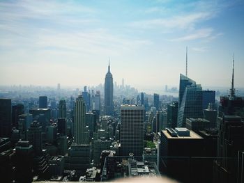 Aerial view of cityscape against sky during sunny day