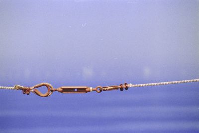 Low angle view of chain against blue sky