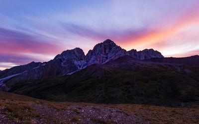 Scenic view of mountains against cloudy sky