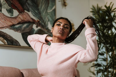 Bored young woman sitting on sofa