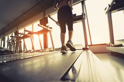 Low section of woman walking on floor