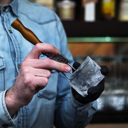 Close-up of man working on cutting board