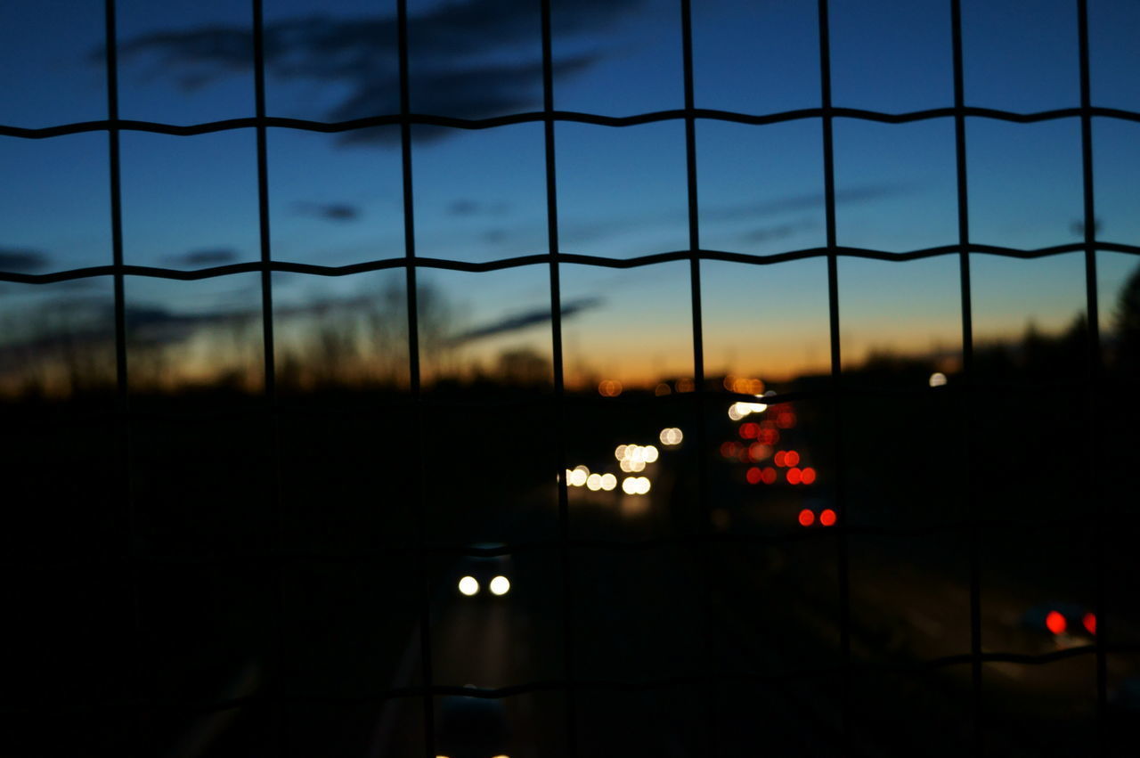 SILHOUETTE OF ILLUMINATED LIGHT AGAINST SKY