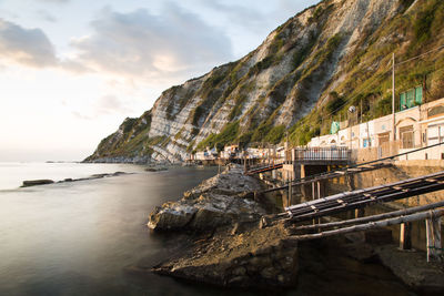 Scenic view of sea and rock formation against sky