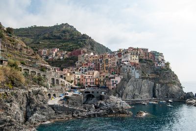 Panoramic view of cliff by sea against sky