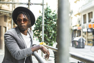 Young man wearing sunglasses standing in city