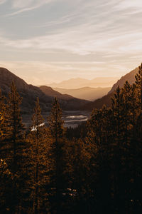 Scenic view of land and mountains against sky