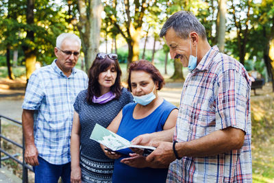 Father and son looking at friends