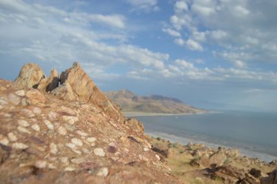 Scenic view of cliff and sea against sky