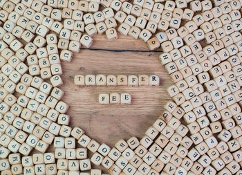 Directly above shot of transfer fee text amidst wooden cubes