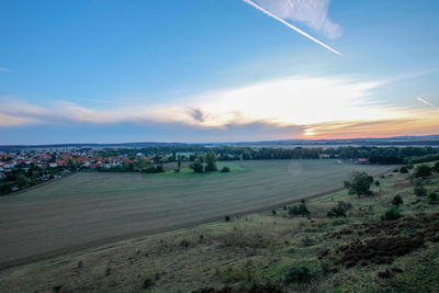 Scenic view of field against sky during sunset