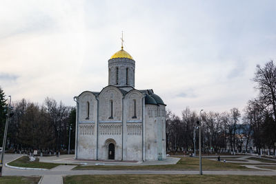 Church by building against sky