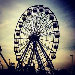 Low angle view of ferris wheel against sky