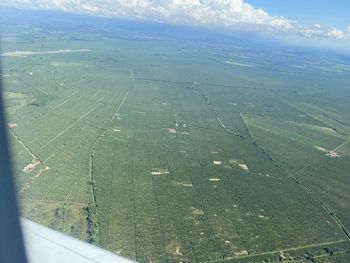 Scenic view of field seen through airplane window