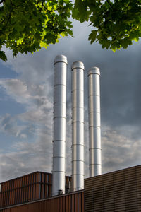 Low angle view of smoke stack against sky