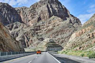 Road leading towards rocky mountains