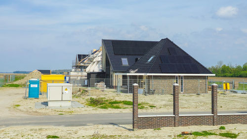 Built structure on field against sky