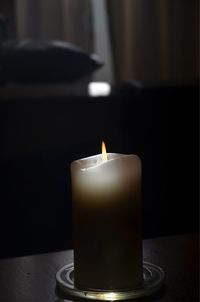 Close-up of illuminated tea light candles on table