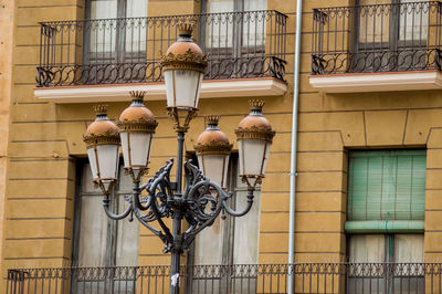 Low angle view of street light against building