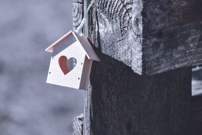 Close-up of birdhouse on wooden post