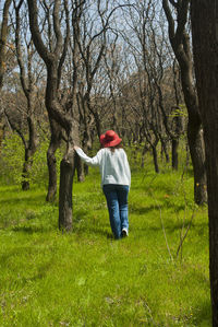 Rear view of woman standing on field