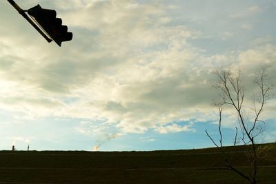 Wind turbines on landscape against sky