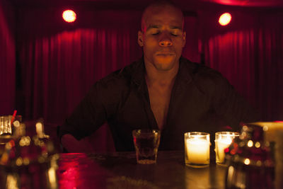 Young man enjoying a drink at a bar