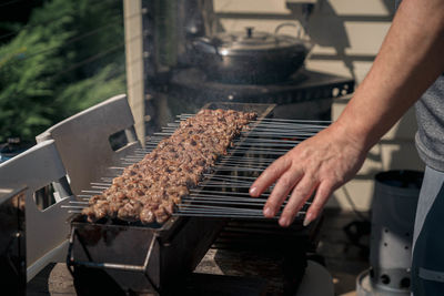 Cropped hand of man preparing food