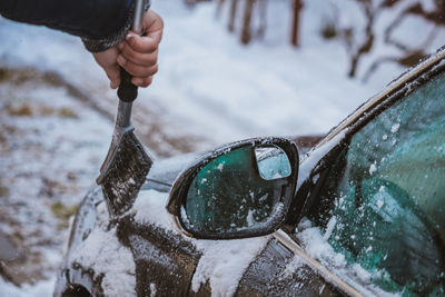 Midsection of man holding ice during winter