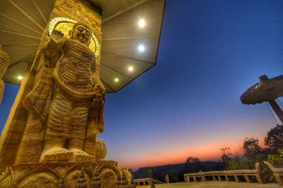 Low angle view of statue against blue sky