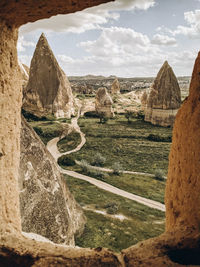 View of old ruins on landscape against sky