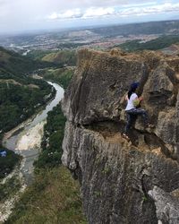 Woman on rock against sky