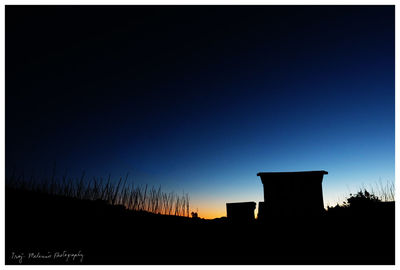 Silhouette of building against blue sky