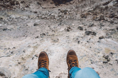 Low section of man standing over rocks