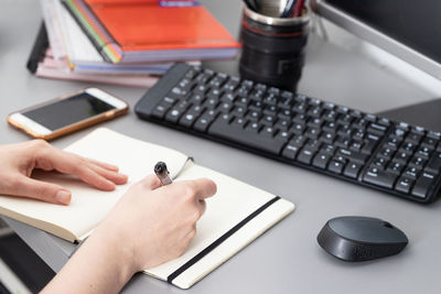 Midsection of man using laptop on table