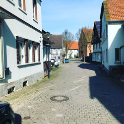 Footpath amidst buildings in city