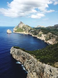 Scenic view of sea and mountains against sky