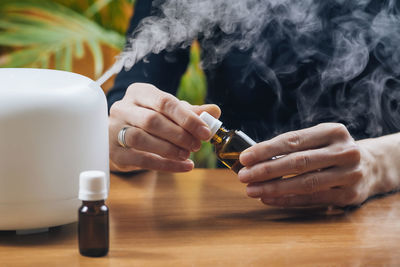 Man smoking cigarette on table