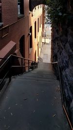 Footpath amidst buildings in city