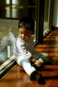 Boy sitting on floor at home