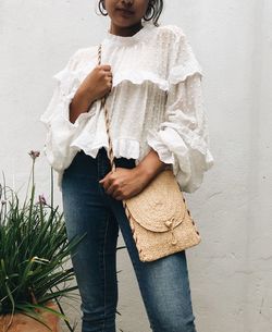 Midsection of woman standing against wall