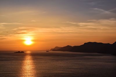 Scenic view of sea against romantic sky at sunset