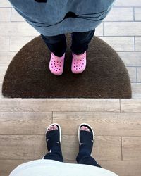 Low section of woman standing on tiled floor